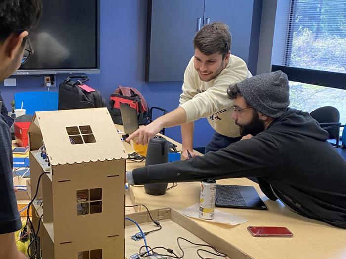 Students in a conference room working on a project