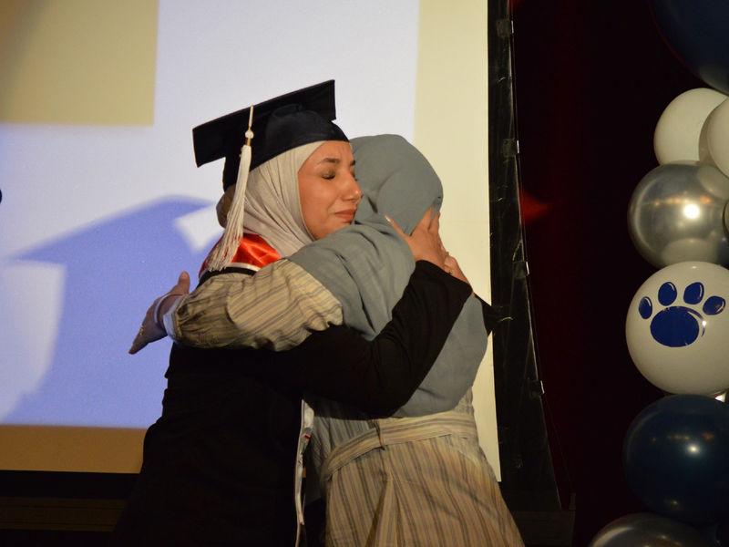 Student and a loved one on stage