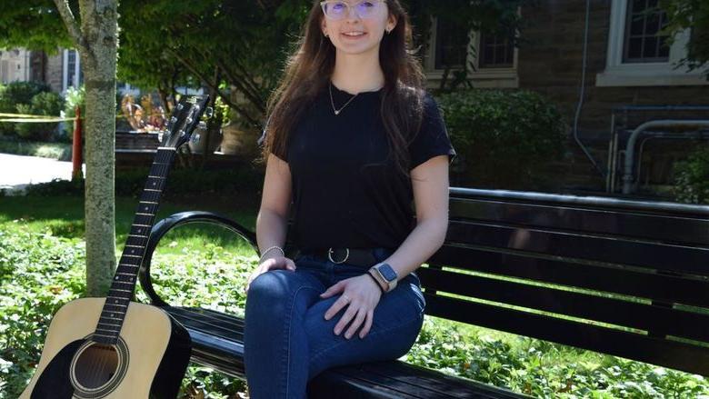 Penn State Abington graduate Vanessa Sexton posing with guitar