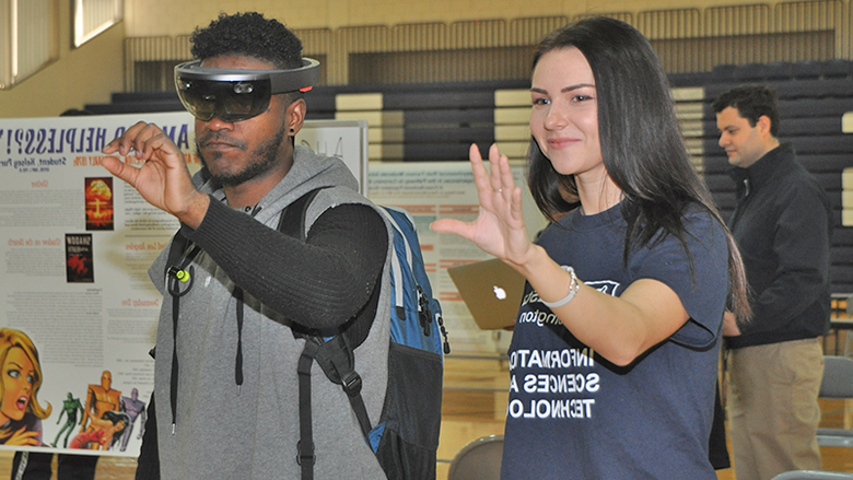 two students at the ACURA Fair