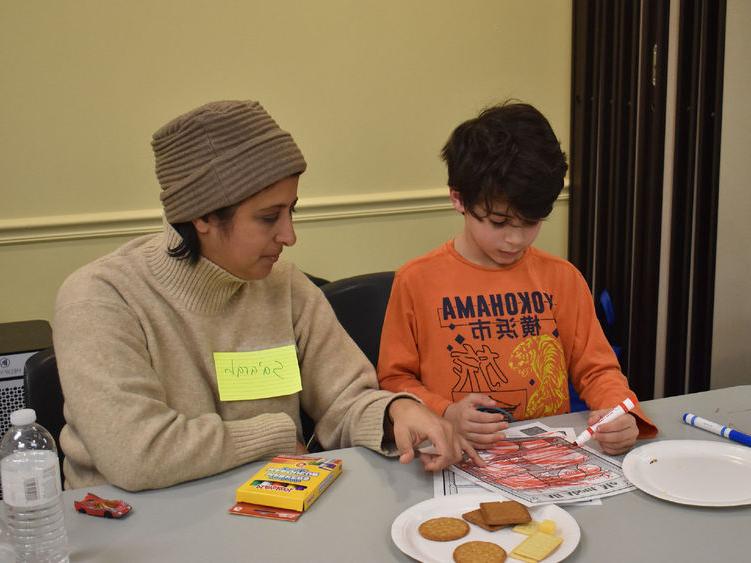 Parent and child completing worksheets